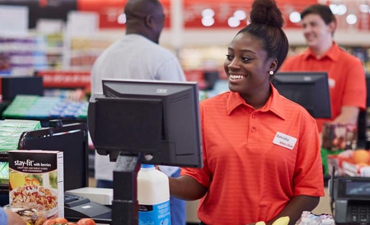 Smiling Winn-Dixie cashier checking out items